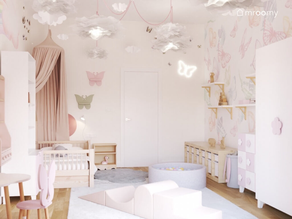 Jasny pokój dziewczynki z ozdobami motylami łóżkiem z baldachimem i papierowymi lampami